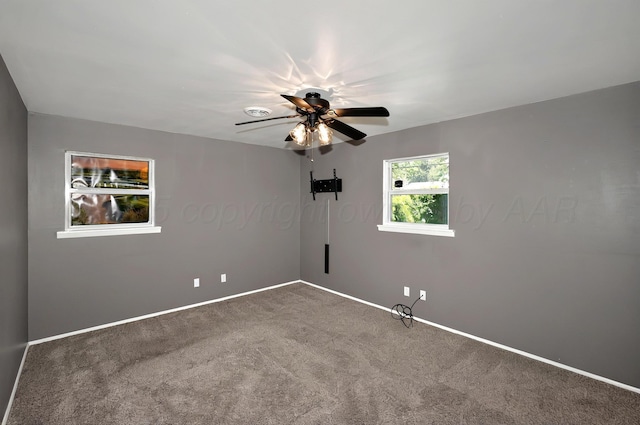 spare room featuring carpet flooring, ceiling fan, and baseboards