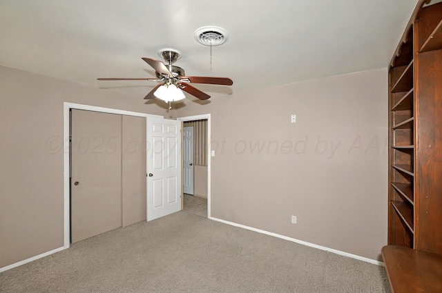 unfurnished bedroom featuring light colored carpet, baseboards, a closet, and ceiling fan