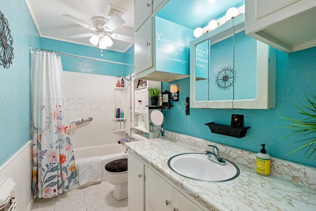 2804 Rule St, Amarillo, TX 79107 - bathroom featuring shower / bath combo with shower curtain, a ceiling fan, tile patterned floors, vanity, and toilet