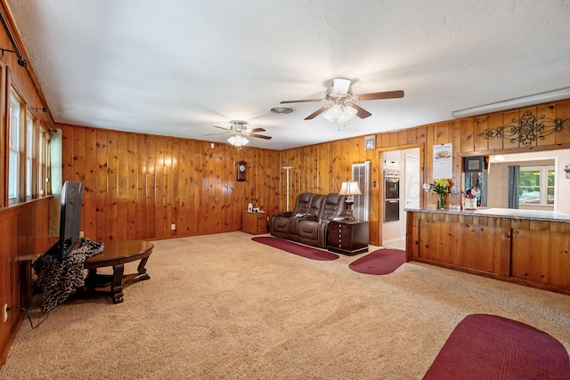 2804 Rule St, Amarillo, TX 79107 - carpeted living area with a ceiling fan and wooden walls