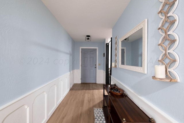 corridor with light hardwood / wood-style floors