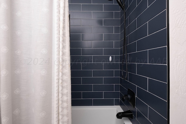 bathroom with shower / tub combo with curtain