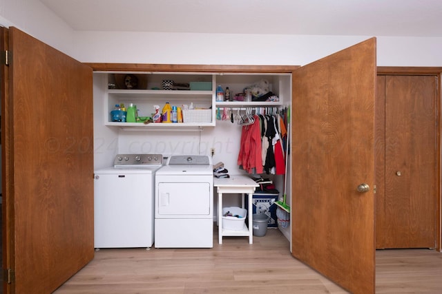 laundry room featuring washer and dryer and light wood-type flooring