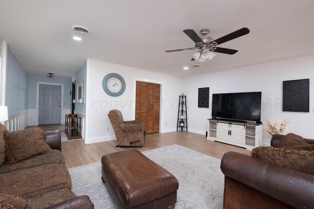 living room with light hardwood / wood-style floors and ceiling fan