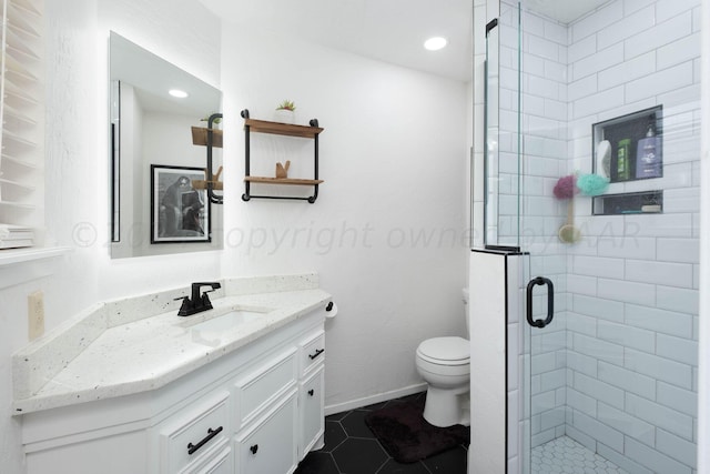 bathroom with toilet, vanity, tile patterned flooring, and walk in shower