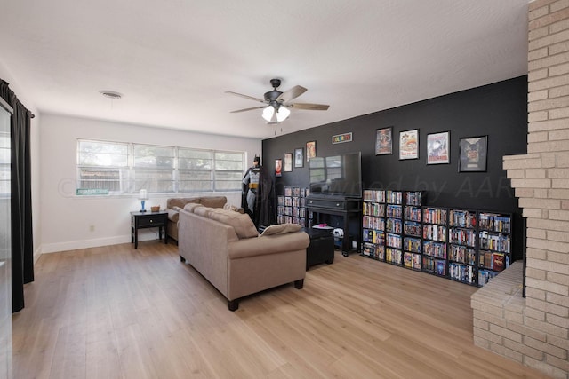 living room with light wood-type flooring and ceiling fan