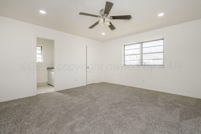 unfurnished bedroom featuring connected bathroom, light colored carpet, a closet, ceiling fan, and multiple windows