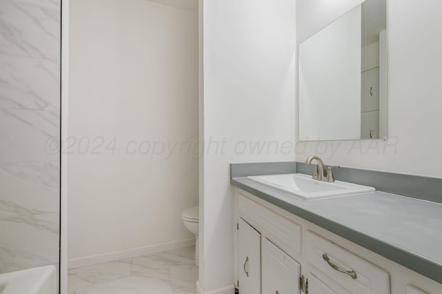 bathroom with vanity, a bathing tub, and toilet