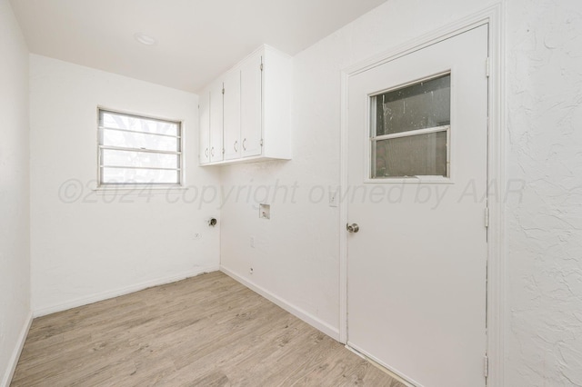 laundry area featuring washer hookup, light wood-type flooring, cabinets, and hookup for an electric dryer