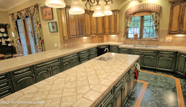 kitchen with tile counters, sink, and backsplash