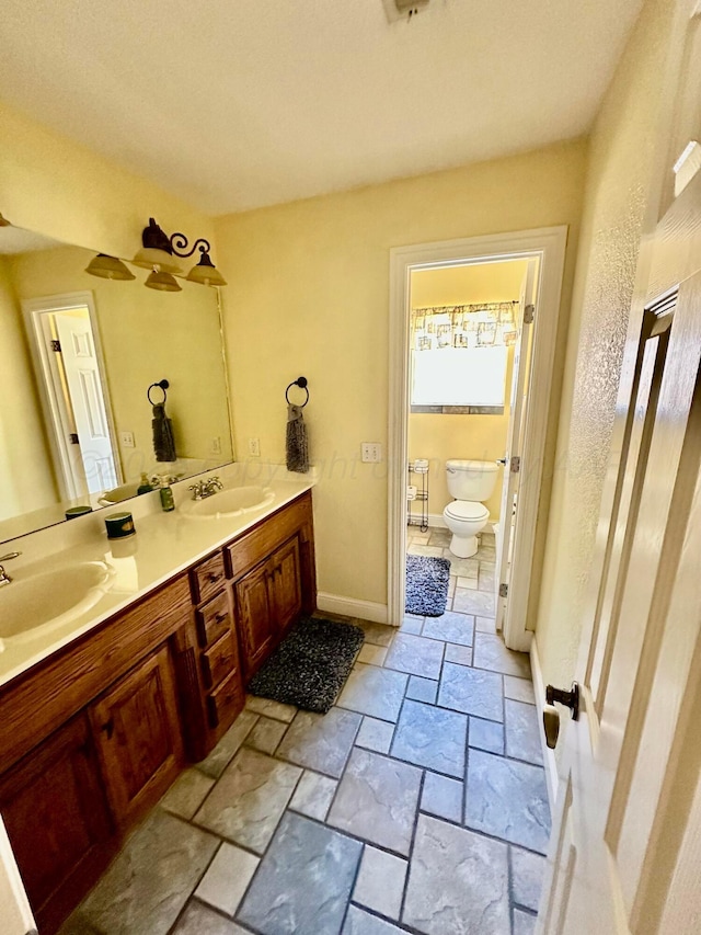 8422 Addison Dr, Amarillo, TX 79119 - bathroom featuring double vanity and stone tile flooring