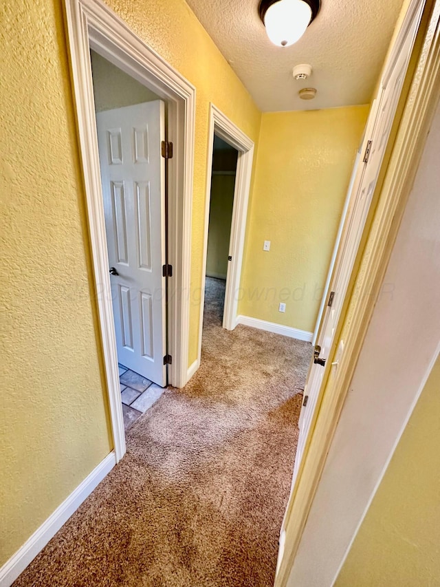 8422 Addison Dr, Amarillo, TX 79119 - hallway featuring carpet, a textured ceiling, and a textured wall