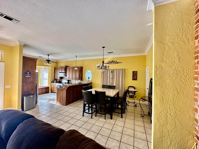 8422 Addison Dr, Amarillo, TX 79119 - dining space with light tile patterned floors, a chandelier, a textured ceiling, ornamental molding, and ceiling fan