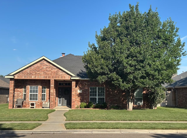 8422 Addison Dr, Amarillo, TX 79119 - view of front of house featuring a front yard, brick siding, and roof with shingles