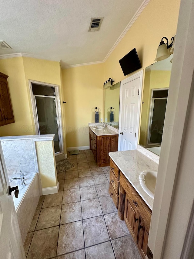 8422 Addison Dr, Amarillo, TX 79119 - bathroom featuring a stall shower, two vanities, ornamental molding, a bath, and a textured ceiling