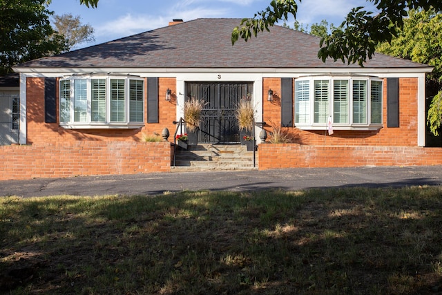 3 Nottingham Rd, Amarillo, TX 79124 - view of front of property featuring brick siding, a shingled roof, and a front yard