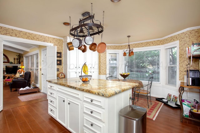3 Nottingham Rd, Amarillo, TX 79124 - kitchen with wallpapered walls, dark wood finished floors, white cabinetry, light stone countertops, and a center island