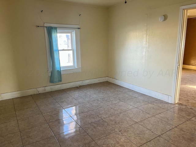 spare room featuring light tile patterned floors