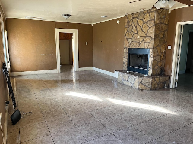 unfurnished living room with ceiling fan and a fireplace