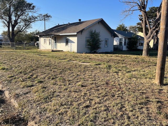 view of side of property with a yard