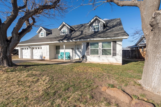 cape cod-style house featuring a front lawn and a garage