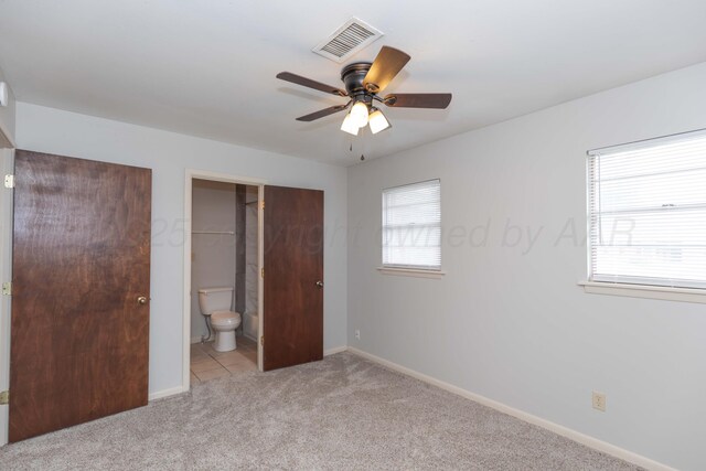 2709 Mohawk Dr, Amarillo, TX 79109 - unfurnished bedroom with light colored carpet, baseboards, ensuite bathroom, and a ceiling fan
