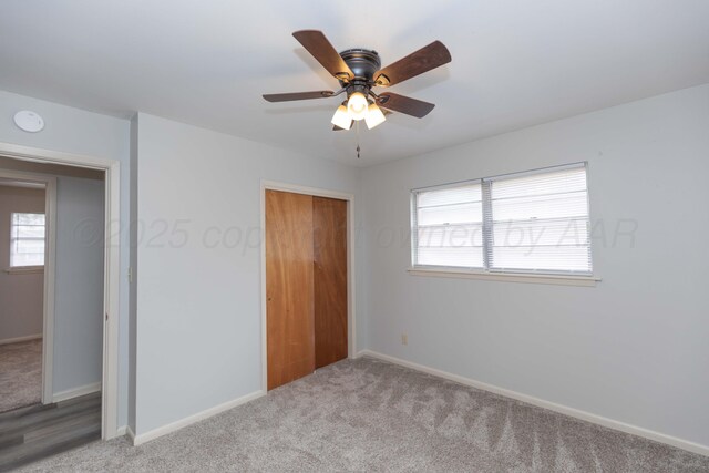 2709 Mohawk Dr, Amarillo, TX 79109 - unfurnished bedroom with carpet flooring, a closet, multiple windows, and baseboards