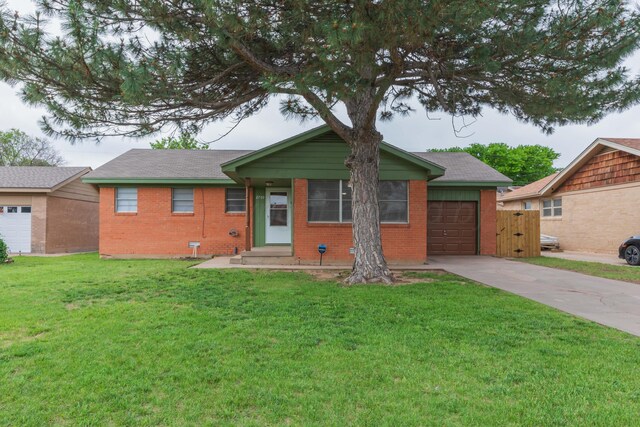 2709 Mohawk Dr, Amarillo, TX 79109 - ranch-style home featuring concrete driveway, a garage, brick siding, and a front lawn