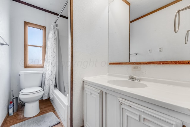 full bathroom with crown molding, toilet, shower / tub combo, vanity, and wood finished floors