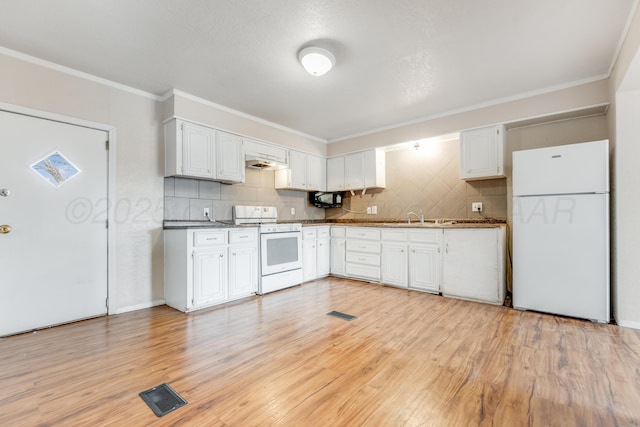 kitchen featuring white appliances, light wood-type flooring, visible vents, and tasteful backsplash