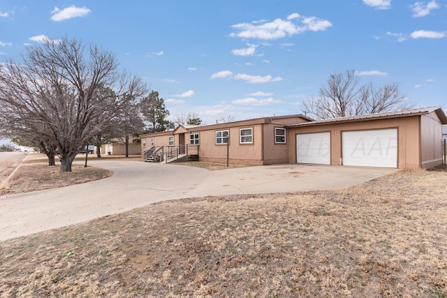 view of front of property with concrete driveway and an attached garage