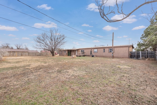 view of yard with fence and a wooden deck