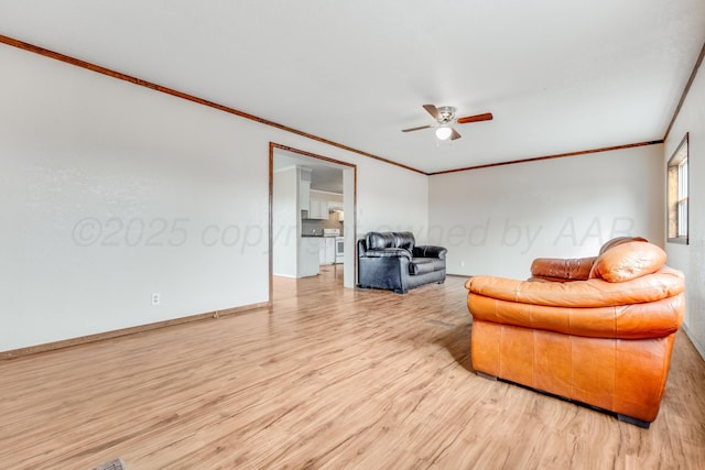 living area with light wood-type flooring, ceiling fan, baseboards, and crown molding