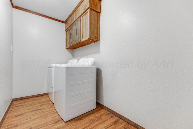 laundry room with washer and dryer, cabinet space, crown molding, and light wood finished floors