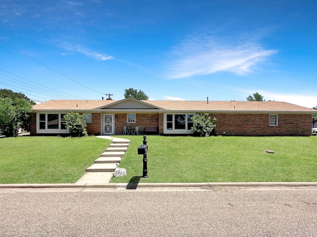 1620 Takewell St, Borger, TX 79007 - ranch-style house featuring a front yard and brick siding