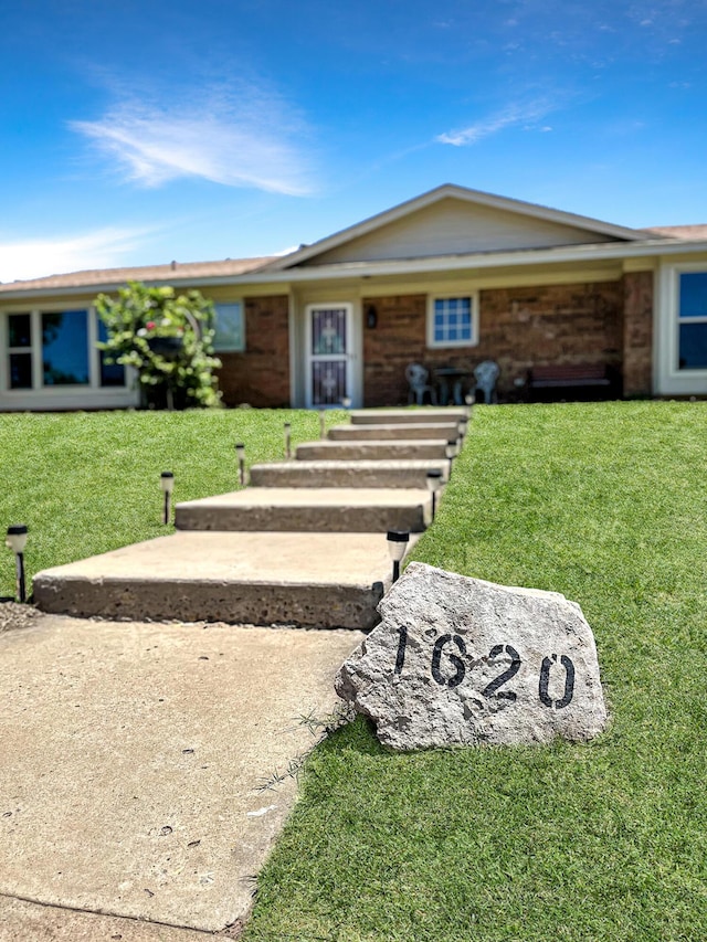 1620 Takewell St, Borger, TX 79007 - single story home with a front lawn and brick siding