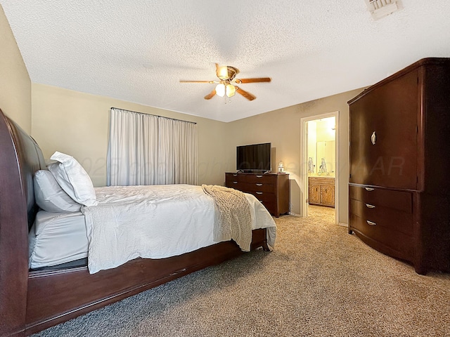 1620 Takewell St, Borger, TX 79007 - bedroom featuring light colored carpet, ceiling fan, a textured ceiling, and ensuite bathroom