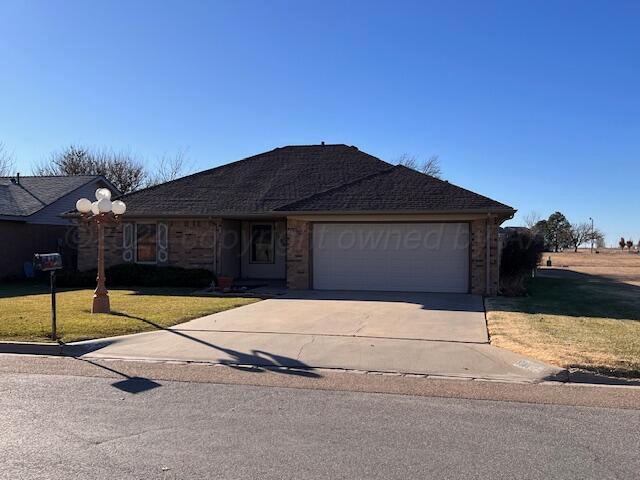 single story home featuring a garage and a front yard