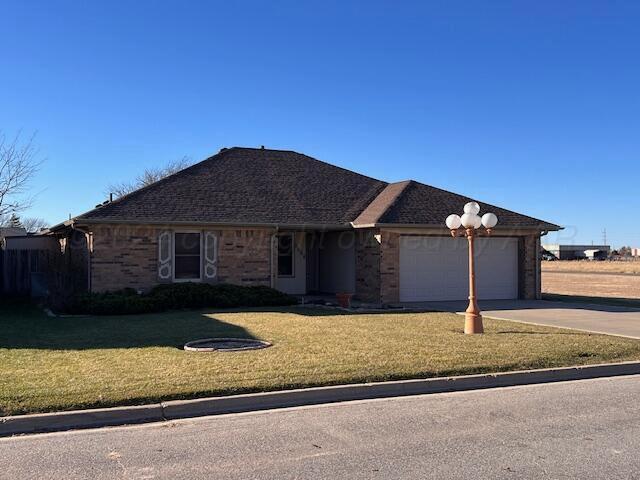 ranch-style home with a front yard and a garage