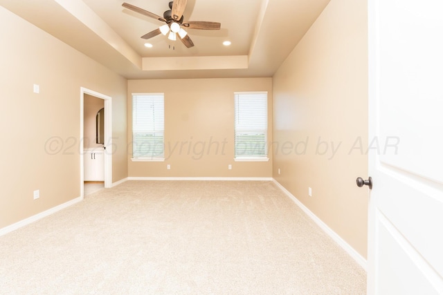 30 Country Club Dr, Farwell, TX 79325 - spare room with light colored carpet, recessed lighting, a ceiling fan, a tray ceiling, and baseboards
