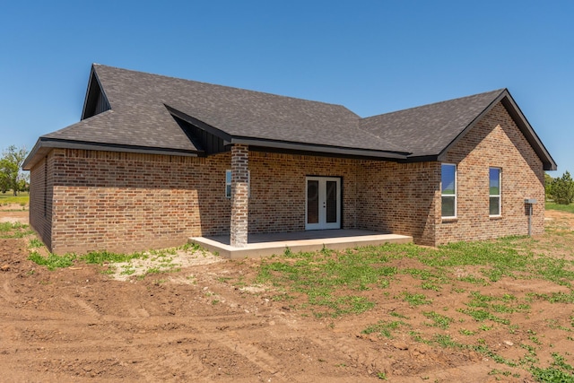 30 Country Club Dr, Farwell, TX 79325 - back of house with brick siding, roof with shingles, french doors, and a patio
