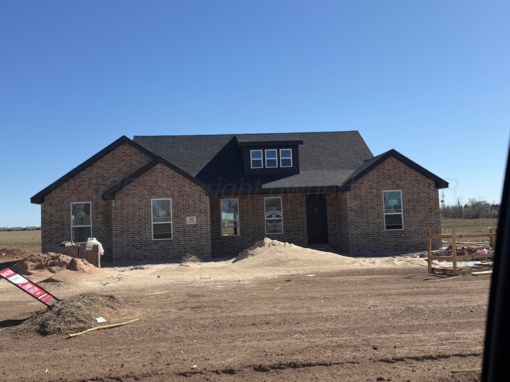 view of front of house with brick siding