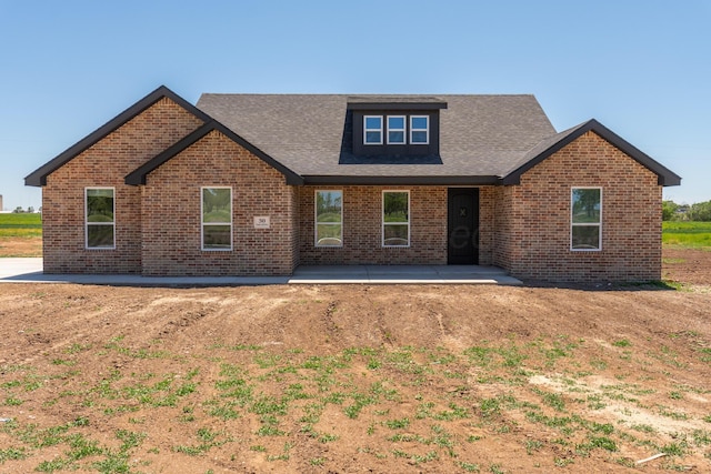 30 Country Club Dr, Farwell, TX 79325 - craftsman house with a patio area, roof with shingles, and brick siding