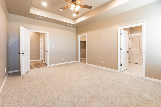 30 Country Club Dr, Farwell, TX 79325 - unfurnished bedroom with baseboards, a raised ceiling, visible vents, and light colored carpet