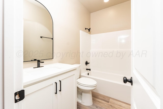 30 Country Club Dr, Farwell, TX 79325 - full bathroom featuring toilet, shower / bathing tub combination, wood finished floors, and vanity