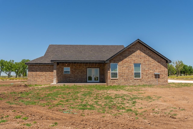 30 Country Club Dr, Farwell, TX 79325 - rear view of house with a shingled roof, brick siding, and french doors