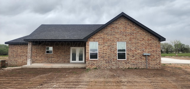 30 Country Club Dr, Farwell, TX 79325 - back of house featuring roof with shingles, french doors, and brick siding