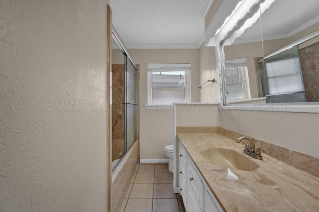 bathroom with vanity, a textured wall, tile patterned floors, crown molding, and toilet