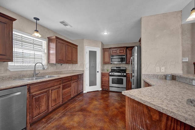 1800 Berkley Ct, Amarillo, TX 79118 - kitchen with appliances with stainless steel finishes, finished concrete floors, light countertops, pendant lighting, and brown cabinetry