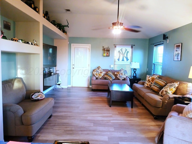 living room featuring wood-type flooring and ceiling fan